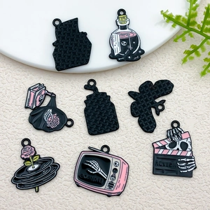 Detailansicht der pink-schwarzen Halloween-Anhänger mit Totenkopf- und Schallplattendesigns