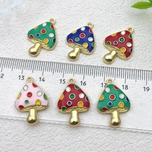 Colorful enamel mushroom pendants set for DIY jewelry making with ruler for size scale