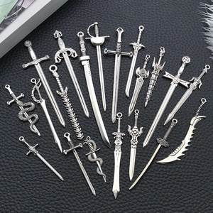 Macro shot of vintage silver alloy sword charms in various styles on black leather