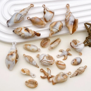 Detailed view of DIY acrylic ocean charms with shell and starfish textures