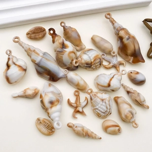 Macro shot of assorted resin shell and starfish charms with brown marble texture