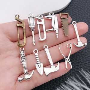 Set of 10 mini alloy hardware tool charms including hammer and wrench for DIY jewelry