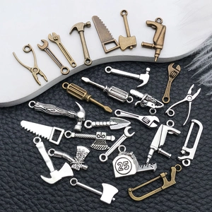 Macro view of silver and bronze alloy hardware tool charms for DIY jewelry and keychains