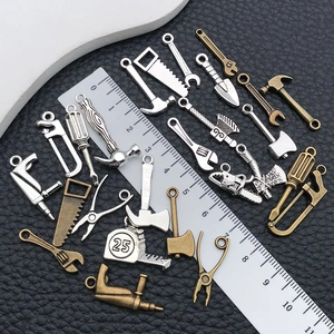 Assorted miniature alloy tool charms including hammers and wrenches for DIY jewelry making