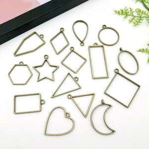 Detailed collection of vintage bronze alloy open bezel pendants in various geometric shapes
