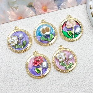Detailed macro view of vintage French floral enamel pendants with gold frames and pearls