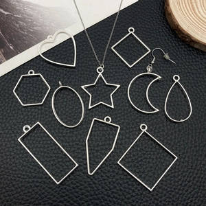 DIY jewelry kit with silver geometric metal charms in heart star and moon shapes