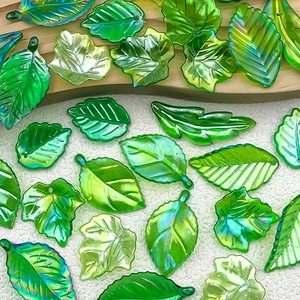 Macro detail of iridescent green leaf-shaped beads for DIY handmade jewelry crafts