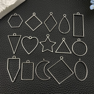 Macro view of 15 silver geometric hollow metal bezel pendants for DIY jewelry making
