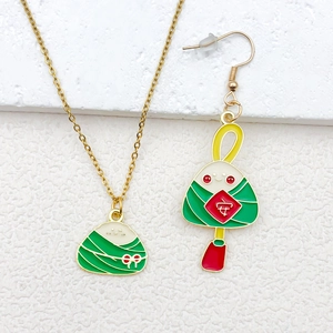 Detail of Zongzi jewelry set with golden chain and festive green cartoon charms