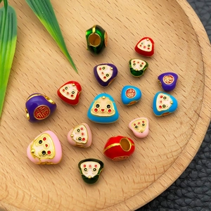 Macro shot of colorful enamel Zongzi beads with Fu character for DIY jewelry making