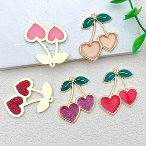 Macro detail of cherry heart alloy pendants in five colors for DIY jewelry making