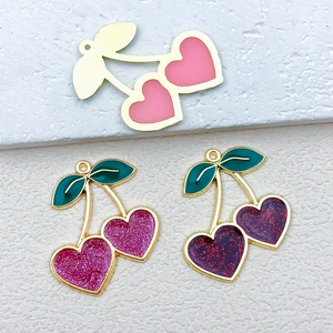 Macro detail of cherry-shaped heart alloy pendants for DIY earrings and jewelry making