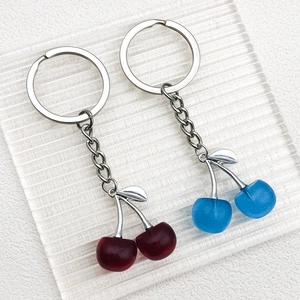 Red and blue cherry crystal pendant keychains with metallic leaves and silver rings