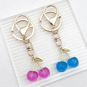 DIY cherry pendant keychain with purple and blue resin fruits and golden metal alloy clips
