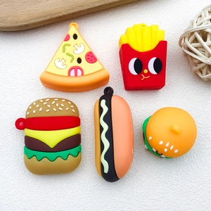 Flat lay detail of silicone food charms featuring pizza, fries, burger, and hot dog set
