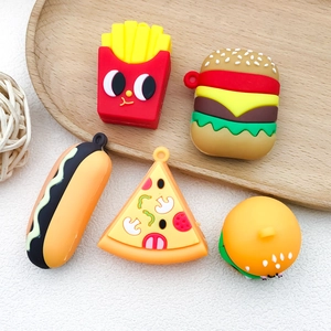 Macro detail of miniature PVC fast food charms including burger and pizza on a wooden tray