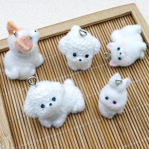 Detail of five handmade flocked resin Corgi and animal charms with silver metal rings