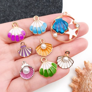 Detail showing colorful enamel sea shell pendants with pearls for DIY jewelry making