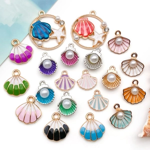 Macro shot of colorful enamel sea shell and starfish pendants with pearls for jewelry making