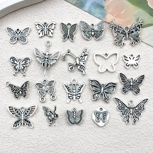 Flat lay of nineteen different antique silver butterfly charms for DIY jewelry making