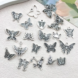Detailed macro view of vintage silver alloy butterfly charms for jewelry making DIY
