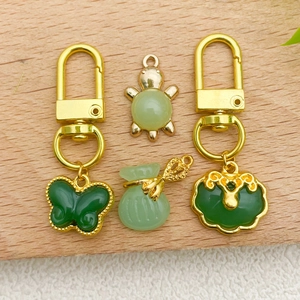 Chinese style green faux jade charms with gold plating including butterfly and luck bag shapes