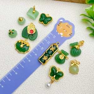 Chinese style emerald green jade pendants with gold metal trim in various shapes
