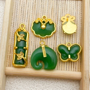 Detailed macro view of New Chinese style imitation jade and gold alloy pendants on bamboo tray