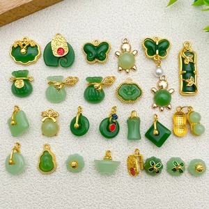 Collection of green faux jade charms with lucky Chinese symbols and gold metal edges