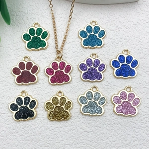Close-up of glittery paw print alloy pendants in various vibrant colors for DIY jewelry