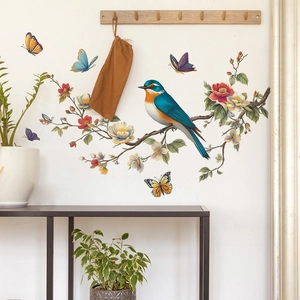 Floral wall sticker featuring a colorful bird on a branch with butterflies in a modern hallway