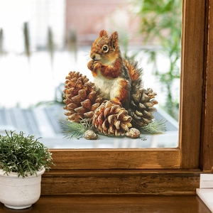 Cute squirrel and pinecones wall sticker applied on a window for home decoration