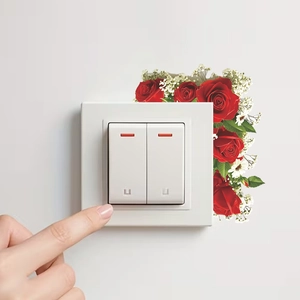 Red rose wall stickers decorating a white double switch panel in a warm living room