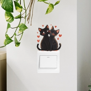 Sticker mural avec deux chats noirs et coeurs rouges pour décorer un interrupteur