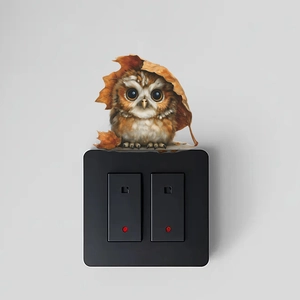3D cartoon owl wall sticker above black switch panel on minimalist gray wall decor