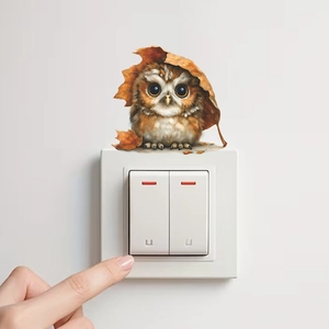 Cute cartoon brown owl wall sticker with maple leaf above white light switch on wall
