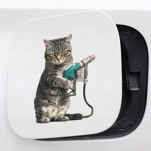 Creative gray tabby cat holding a green fuel nozzle sticker for car gas tank covers