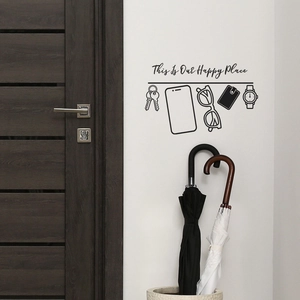 Modern minimalist black wall decal with 'Our Happy Place' text and daily item icons