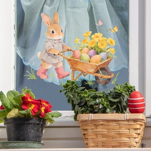 Easter bunny sticker pushing cart with colorful eggs and flowers on glass window