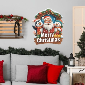 Christmas wall decal with Santa Claus, penguin, and snowman over a gray sofa