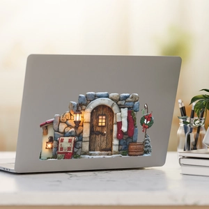 Christmas stone house decal with wreath and socks on a silver laptop lid back