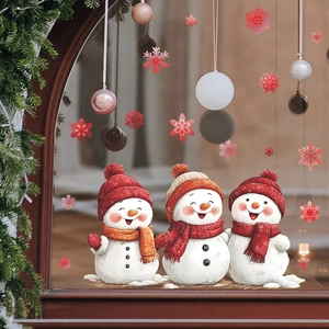Christmas window stickers with cute snowmen and red snowflakes on a glass window frame