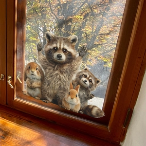 Charming raccoon and rabbit wall stickers on a window glass with autumn leaves background