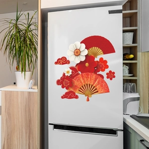 Chinese festive wall stickers with plum blossoms and fans on a white refrigerator