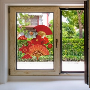 Festive Chinese New Year window stickers with fans and plum blossoms on glass