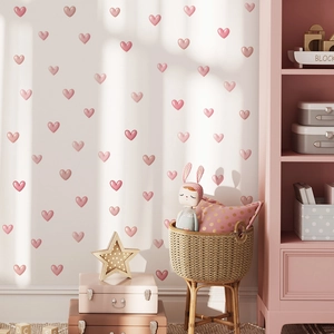 Pink heart-shaped wall stickers for nursery decor in a cozy macaron-toned bedroom setting