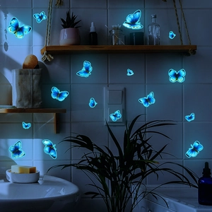 Luminous blue butterfly wall decals for home decor glowing on bathroom tiles