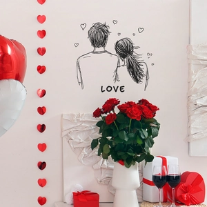 Romantic couple embrace wall sticker with LOVE lettering and heart motifs in black finish