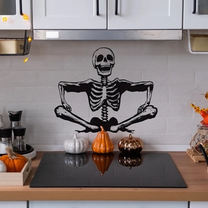 Smiling skeleton wall decal for Halloween home decor on white tile with pumpkins